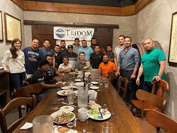 Tridom Roofing crew members at dinner