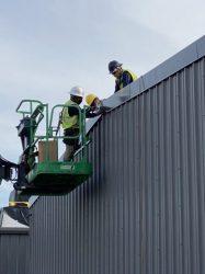 Roofing contractors on lift